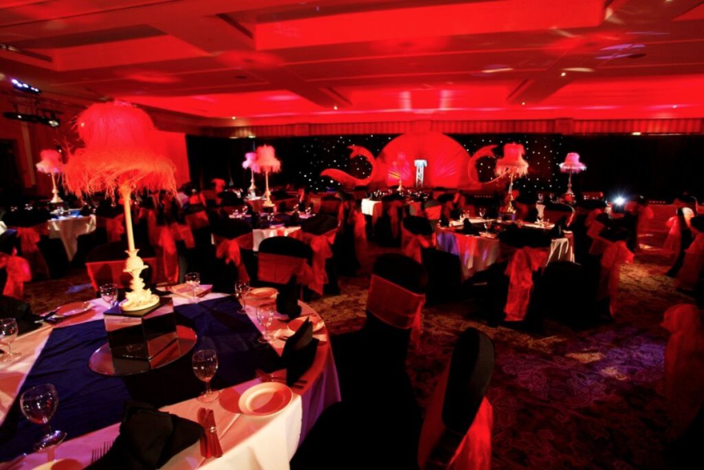 burlesque themed event table centres red star cloth draping lampshade table centres