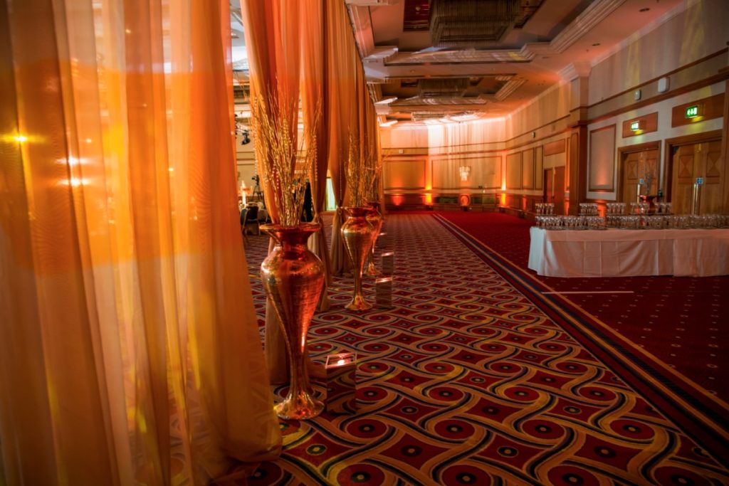 Gold Shimmer Draping at Hilton Birmingham Metropole gold vases up lighters gold twigs and pearls