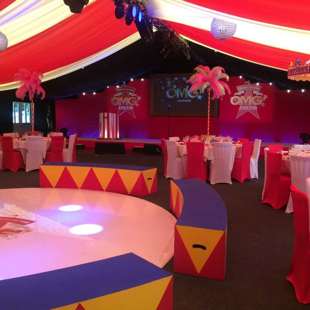 circus themed event tall feather table centre red and white table centres