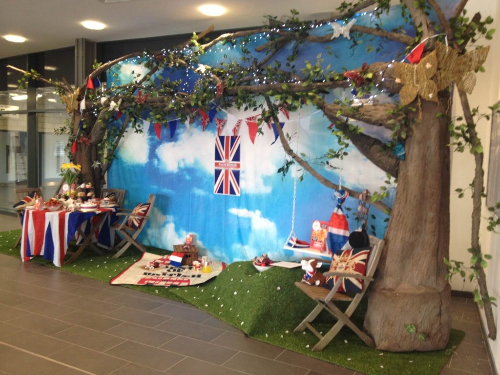 Great British Garden Party installation instagram opportunities fake tree swing union jack lights cloud sky back drop