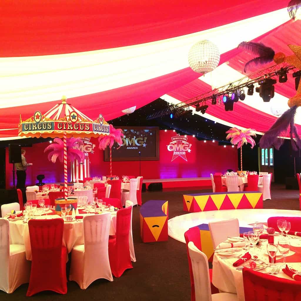 Circus themed room with red and white draping and circus table centrepieces