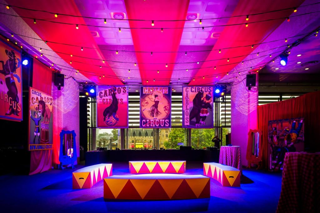 The Greatest Showman Theme festoon lighting red ceiling draping circus posters hanging ring master podium funriture