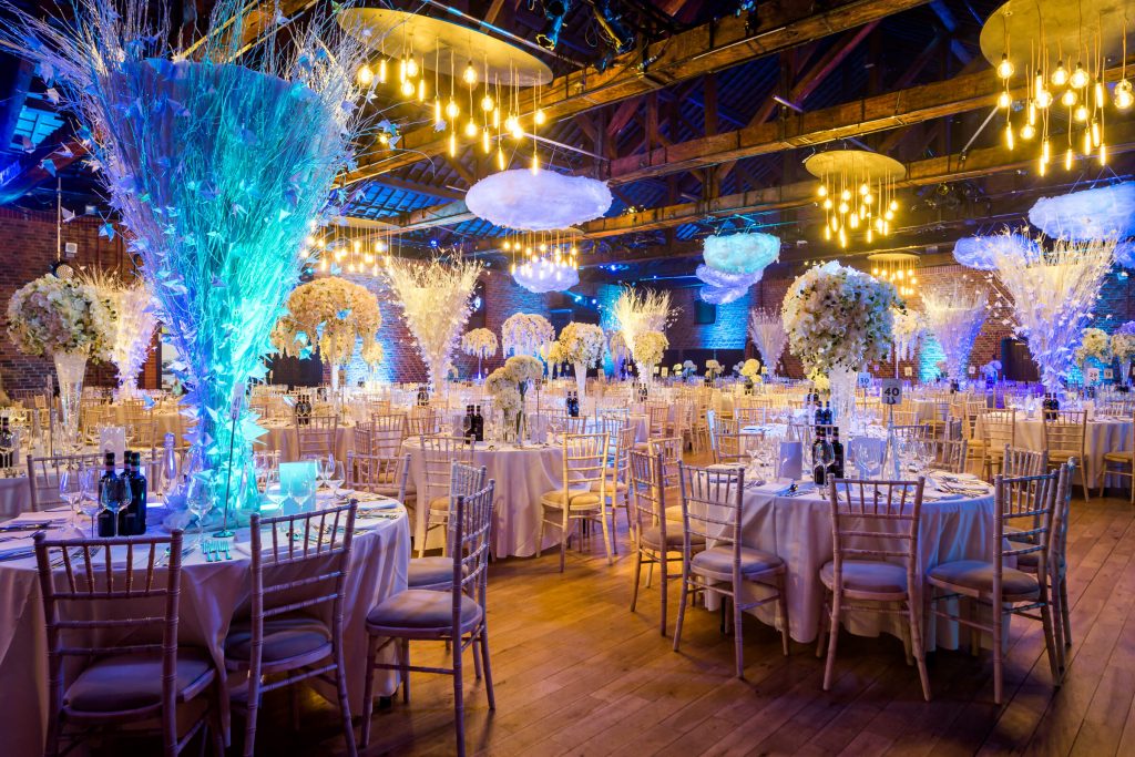 tall white twig table centres blue lighting yellow bright hanging ceiling lights clouds floral displays