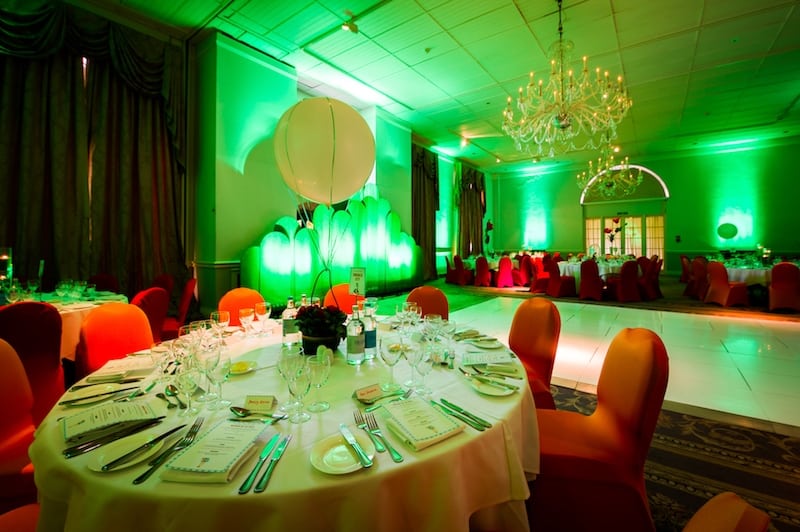 Gala dinner event with red chairs and balloon table centres white dance floor