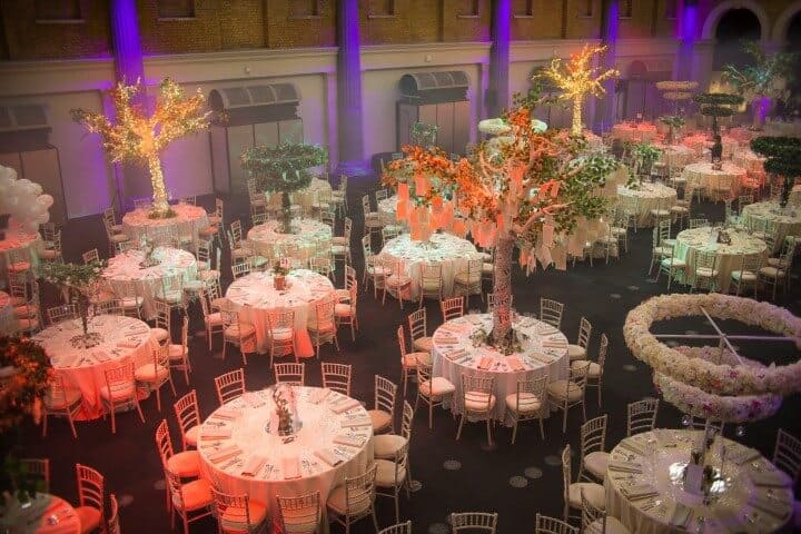 Garden themed event with faux tree props as centrepieces