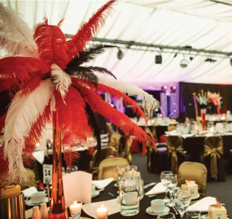 Red and White feather table centrepiece with gold chairs