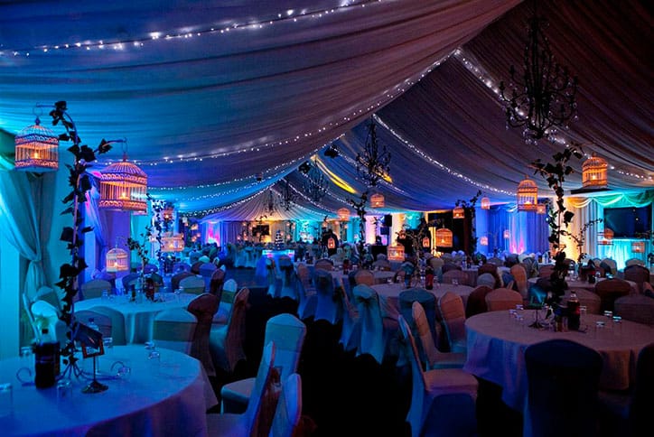 Midsummer Night's Dream Theme table centres birdcages fairy lights ceiling draping