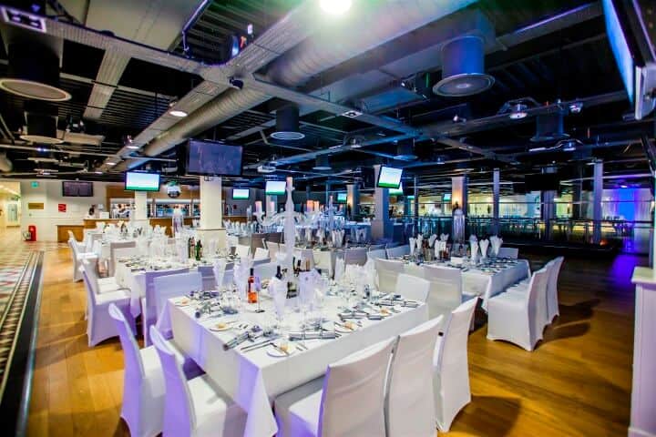 White white chair covers with square tables set for dinner conference