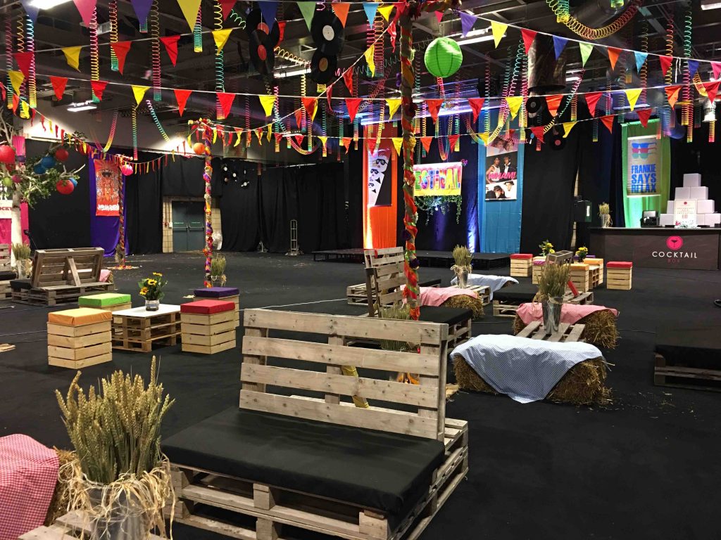indoor festival set up pallet furniture bunting hay bales colourful
