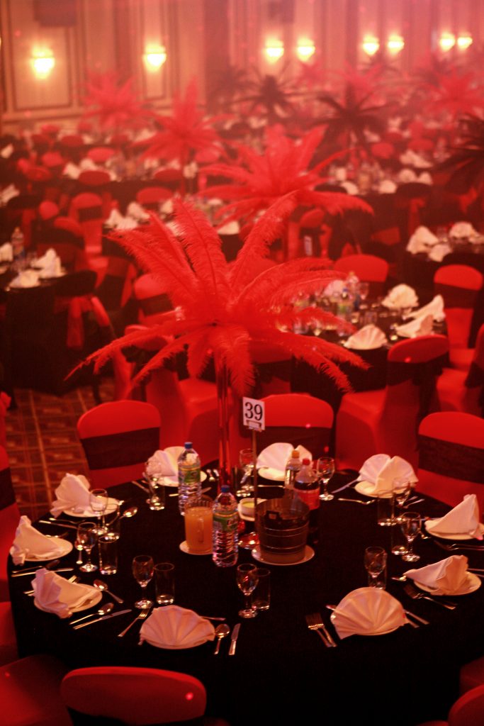 tall red feather table centre burlesques themed event